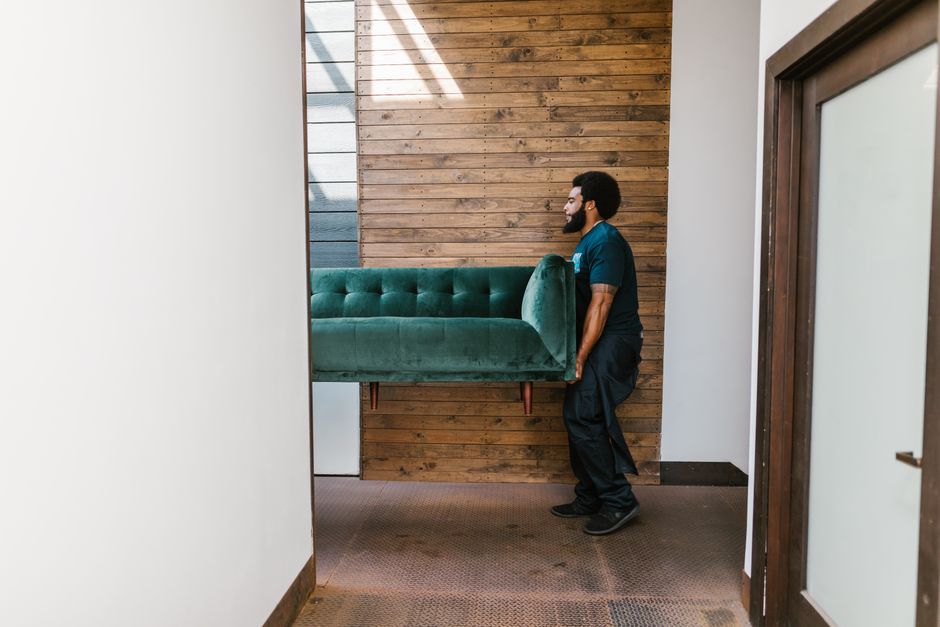Professional movers carrying heavy furniture